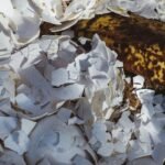 a banana sitting on top of a pile of shredded paper